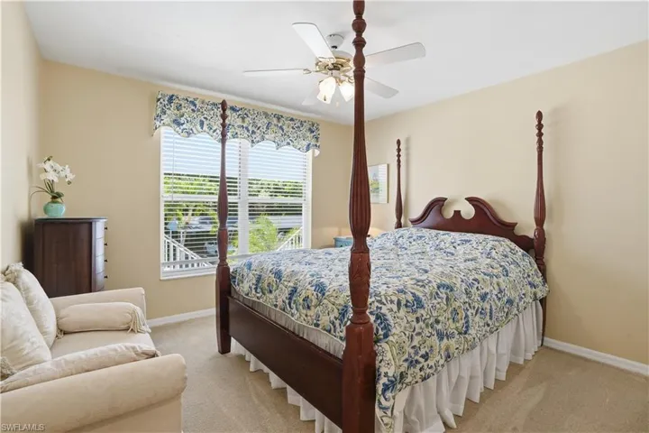 Bedroom featuring carpet, ceiling fan, and a closet