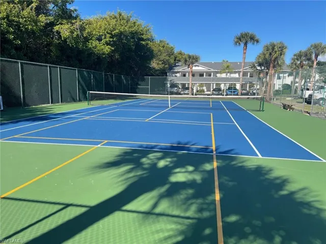 View of tennis court featuring community basketball court
