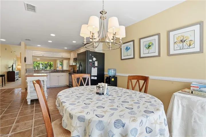 Bedroom with light colored carpet and a ceiling fan