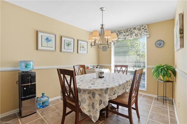 Dining space with a chandelier and baseboards