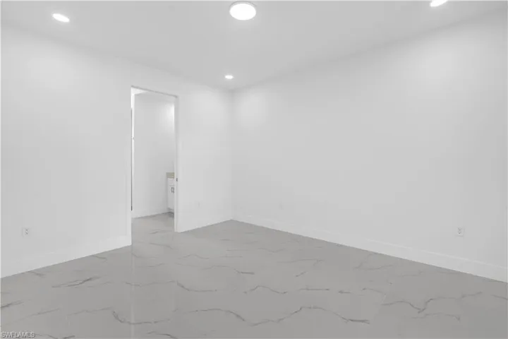 Empty room with recessed lighting and light marble finish floors