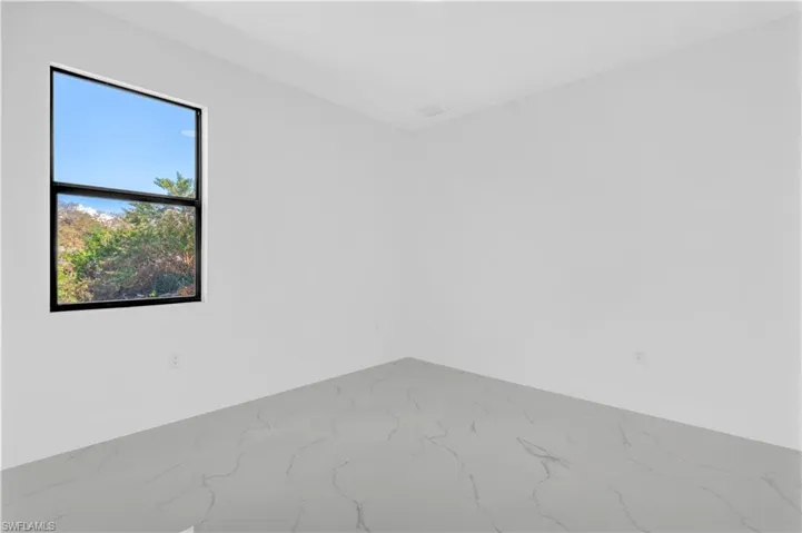 Empty room featuring baseboards