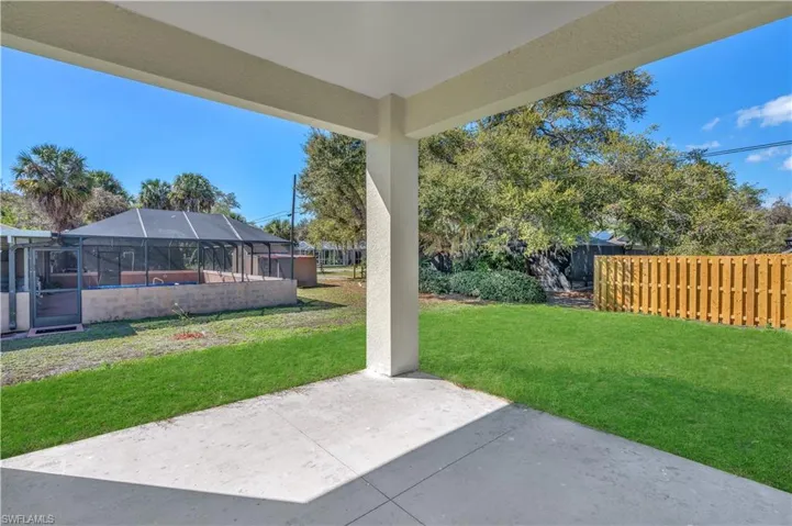 Fenced backyard featuring a patio, a lanai, and a sunroom