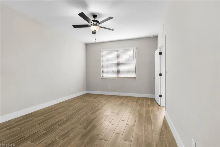 Unfurnished room featuring wood tiled floors and ceiling fan