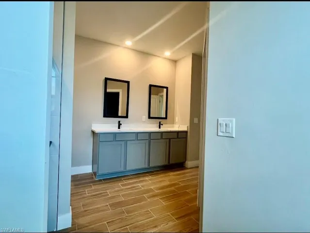 Empty room with baseboards and wood finish floors