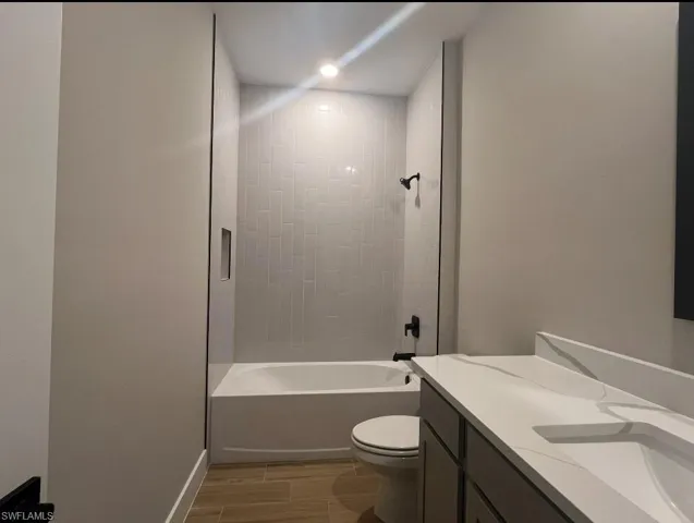 Laundry room featuring wood tiled floors, washer hookup, and hookup for an electric dryer