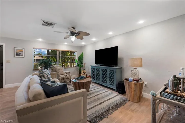 Living room featuring light hardwood / wood-style floors and ceiling fan