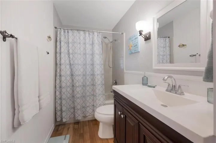 Guest Bathroom featuring vanity, toilet, and hardwood / wood-style floors