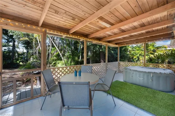 Sunroom / solarium featuring beamed ceiling and wooden ceiling