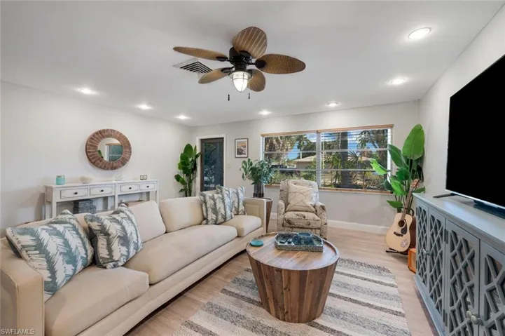 Living room featuring light hardwood / wood-style floors and ceiling fan