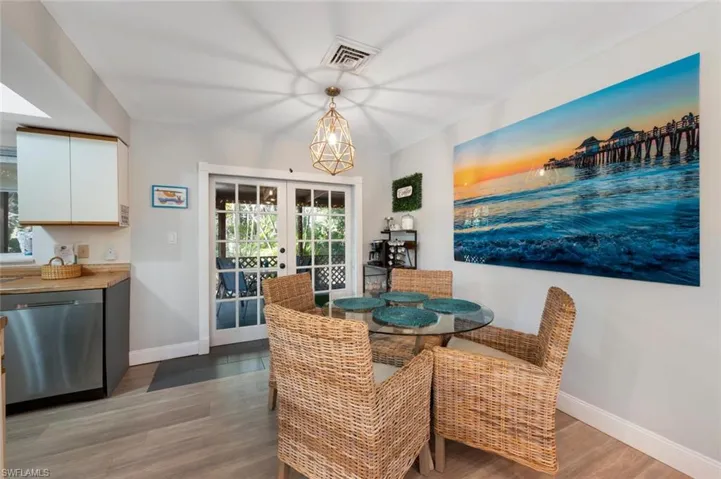 Dining space featuring wood-type flooring and french doors