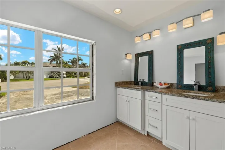 Bathroom with tile patterned floors and vanity
