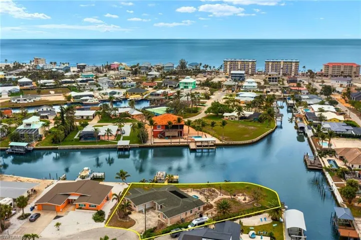 Birds eye view of property with a water view virtually enhanced images