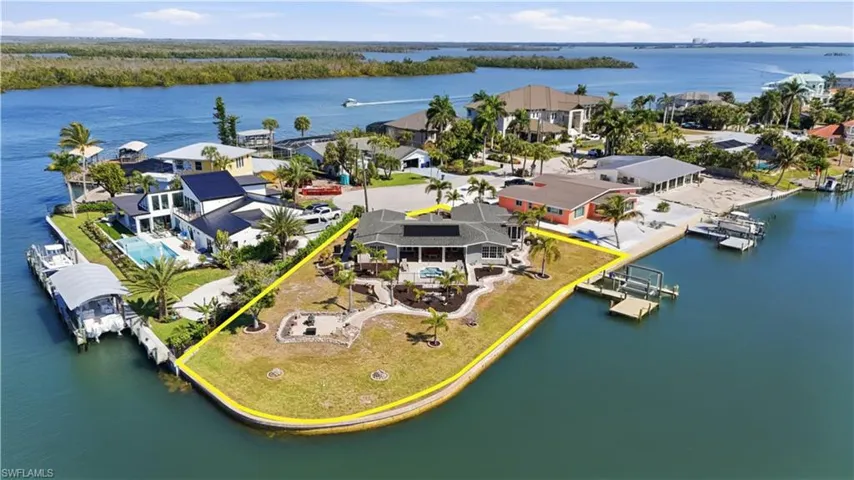 Aerial view of residential area featuring a nearby body of water - Virtually Edited Image