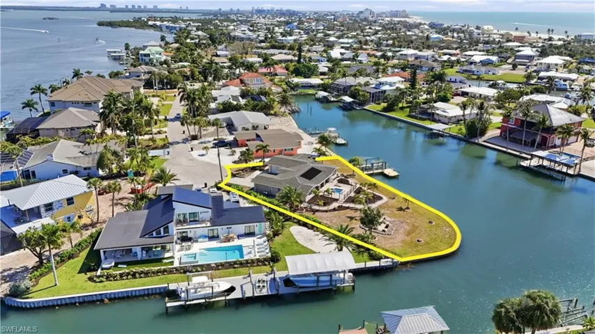 Aerial view of residential area featuring a nearby body of water - Virtually Edited Image