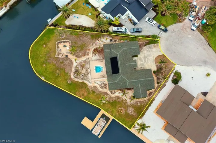 Birds eye view of property with a water view virtually enhanced images