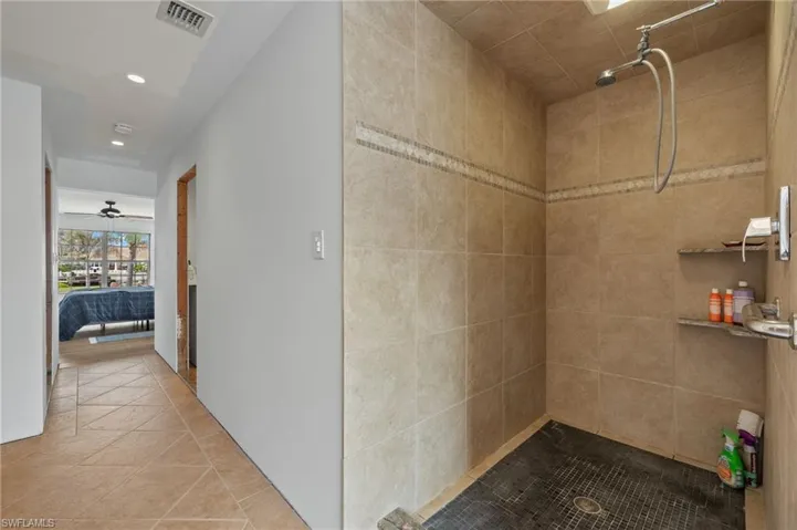Hall featuring light tile patterned flooring