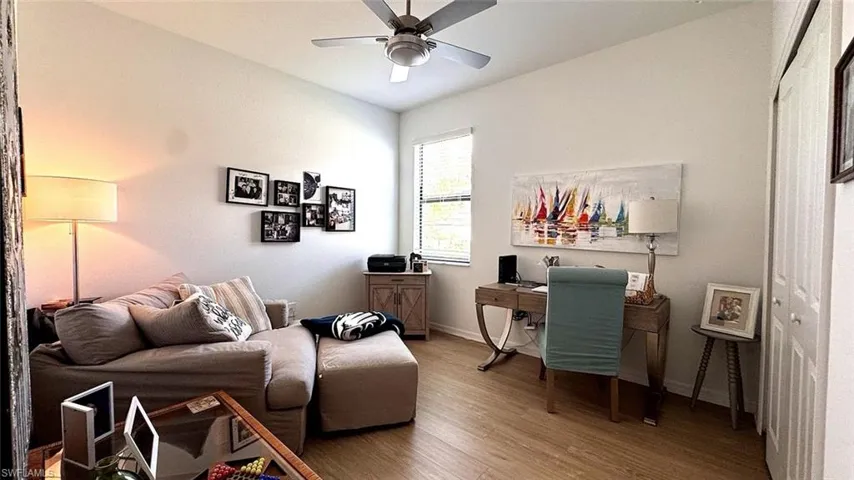 Office area featuring ceiling fan and wood finished floors
