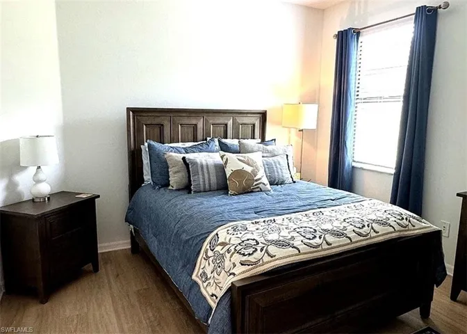 Bedroom featuring baseboards and wood finished floors