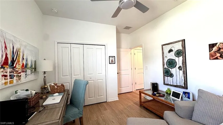 Home office featuring a ceiling fan and wood finished floors
