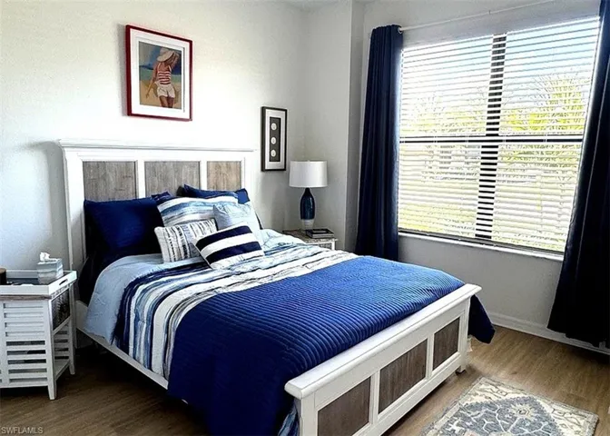 Bedroom featuring wood finished floors and baseboards