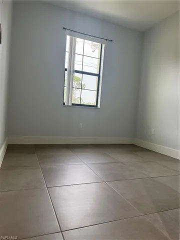 Spare room featuring baseboards