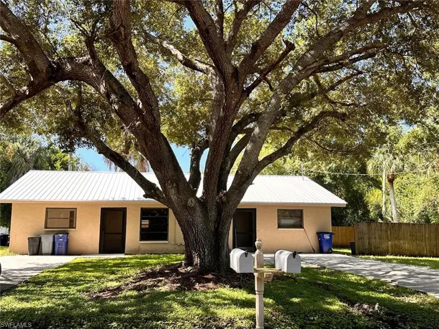 Ranch-style home featuring a front yard