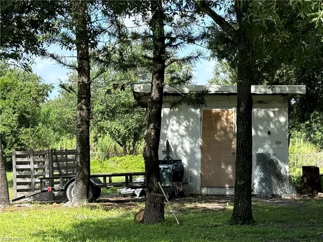 View of outbuilding featuring a yard