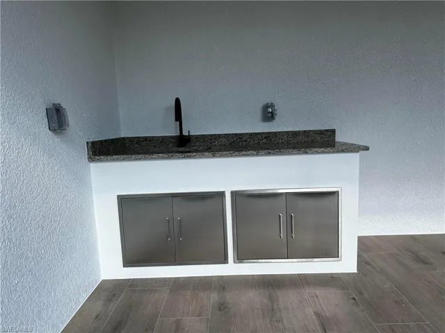 Interior details featuring hardwood / wood-style flooring and sink