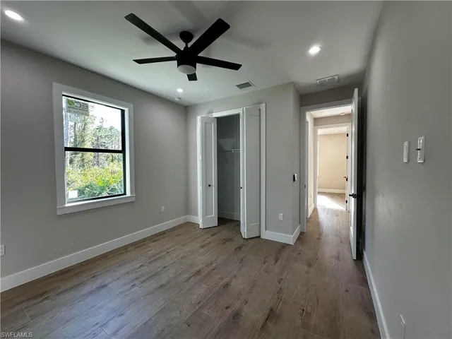 Unfurnished bedroom featuring a closet, light wood-type flooring, and ceiling fan