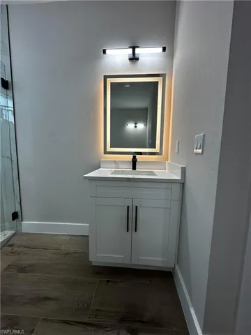 Bathroom with vanity and hardwood / wood-style floors