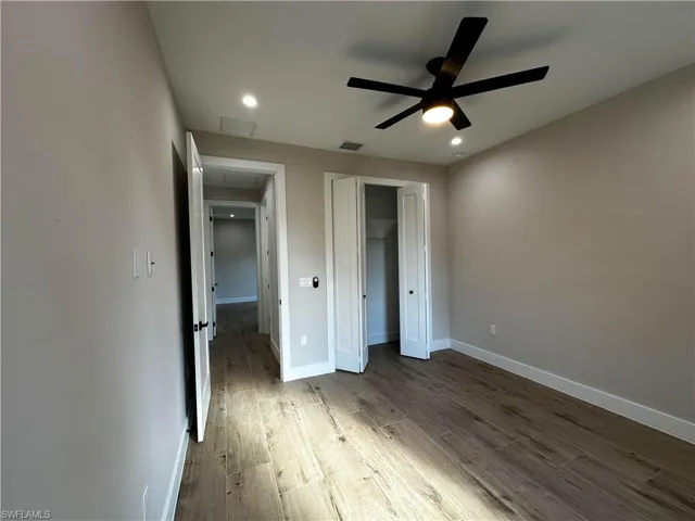 Unfurnished bedroom featuring ceiling fan, a closet, and hardwood / wood-style floors