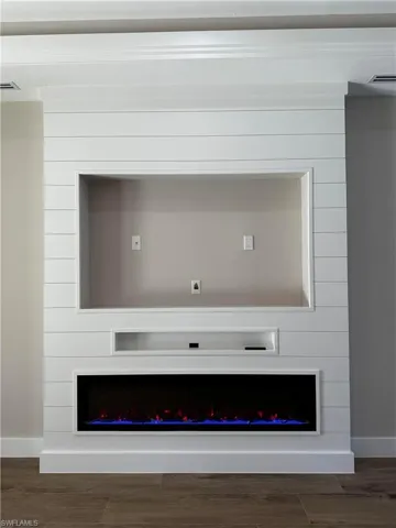 Details featuring hardwood / wood-style flooring and a large fireplace