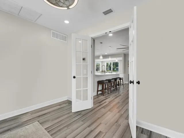 Unfurnished room with light hardwood / wood-style floors and ceiling fan