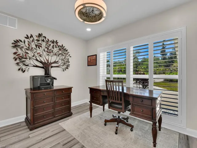 Home office with light wood-type flooring