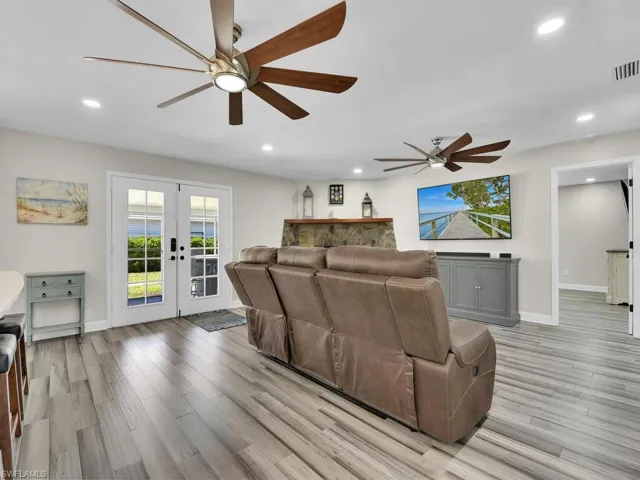 Living room featuring french doors, light hardwood / wood-style flooring, and ceiling fan