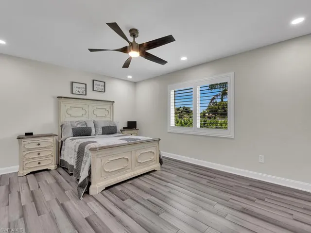 Bedroom with ceiling fan and light hardwood / wood-style flooring