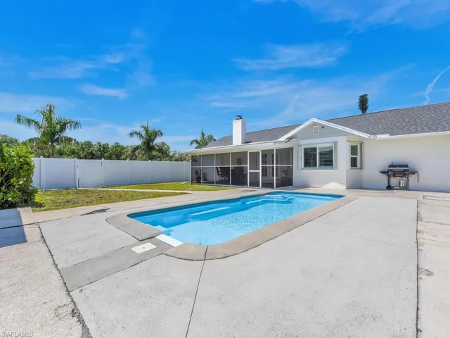 View of swimming pool featuring grilling area, a patio, and a sunroom
