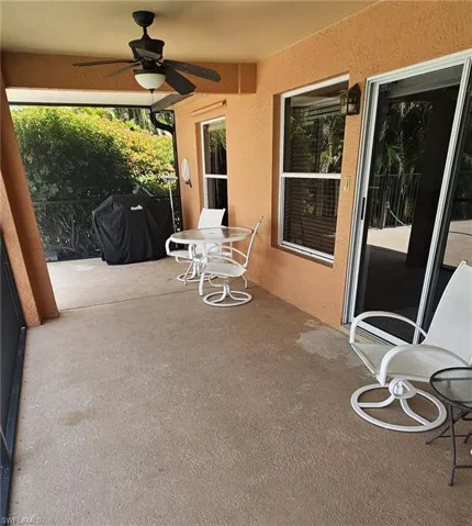 Screened patio with a textured concrete floor, recessed lighting, and a ceiling fan