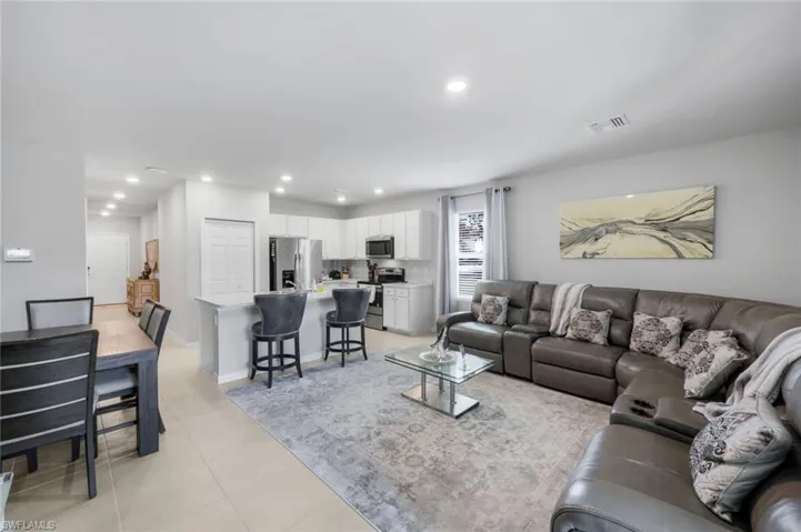 Living area with recessed lighting and light tile patterned floors