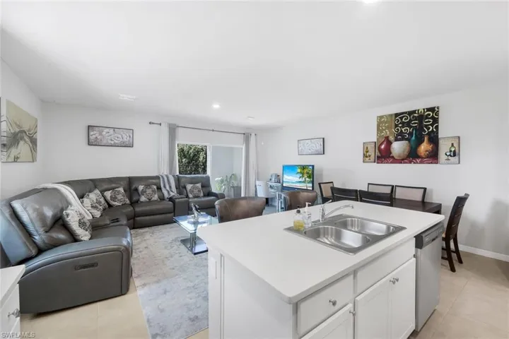 Living area with light tile patterned floors and recessed lighting