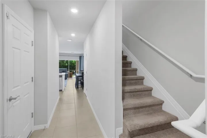 Stairs featuring recessed lighting and tile patterned flooring