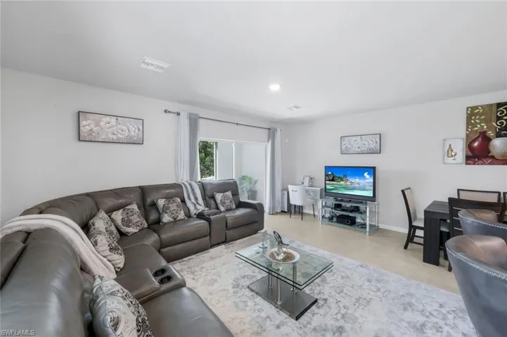 Living room featuring light tile patterned floors and recessed lighting