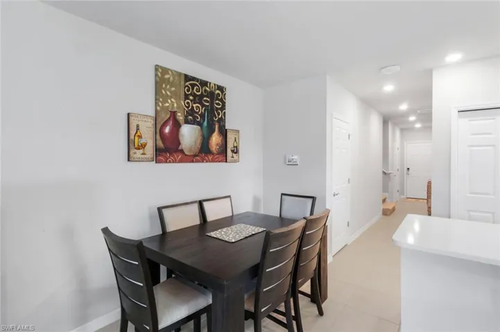 Dining area with recessed lighting and light tile patterned flooring