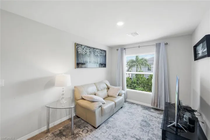 Carpeted living room featuring baseboards