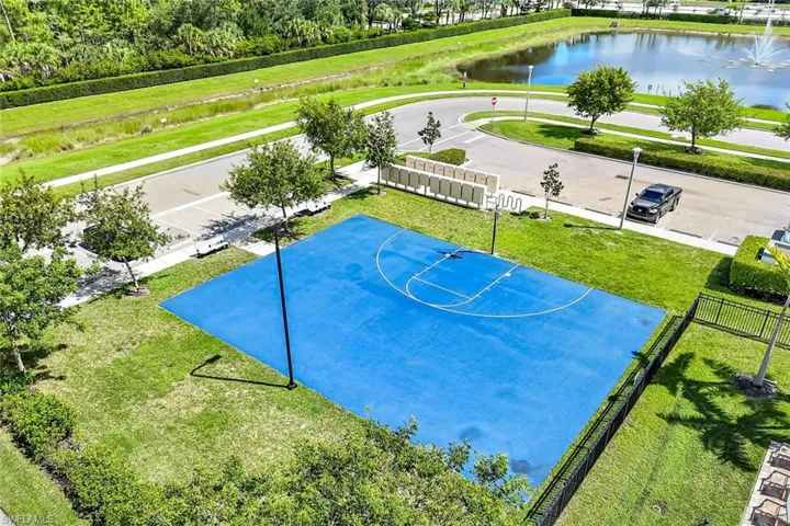 View of basketball court featuring a water view, community basketball court, and a patio area