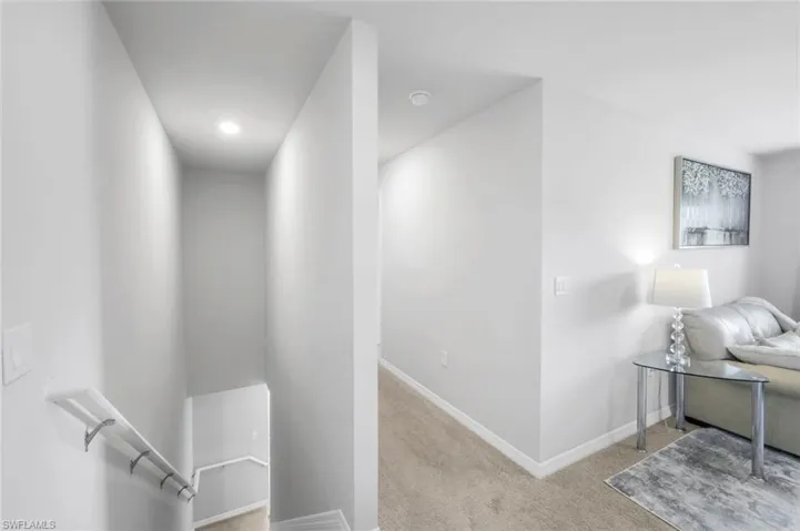 Corridor with carpet and baseboards