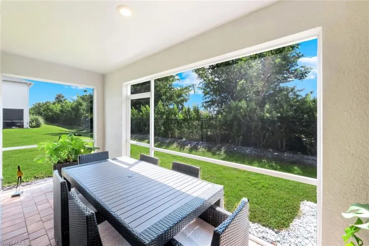Sunroom featuring outdoor dining space and a patio
