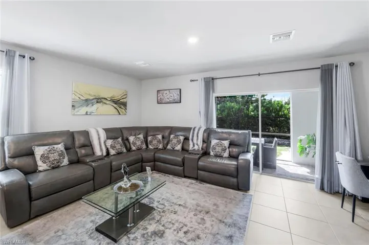 Living area featuring tile patterned floors and recessed lighting