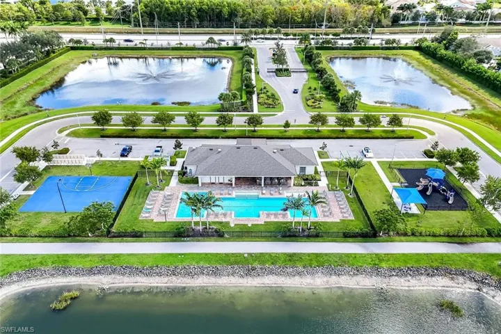 Bird's eye view of a nearby body of water and a pool area